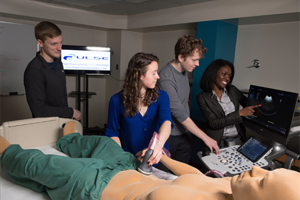 Students practicing surgery in a classroom setting.