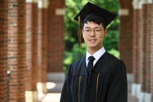 Headshot of William Cho in graduation garb on the Hopkins campus.