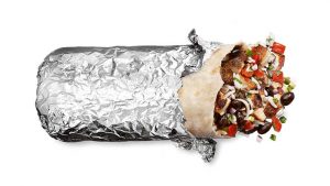 A chicken burrito with bites taken out of it, partially unwrapped from its foil.
