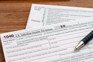 Close-up of a pen and 2022 U.S. Individual Income Tax Return Form 1040.