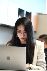Yutong Bai types on an Apple Macbook.