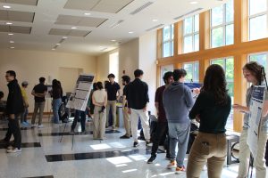 Students attend the Deep Learning Spring 2023 poster session.