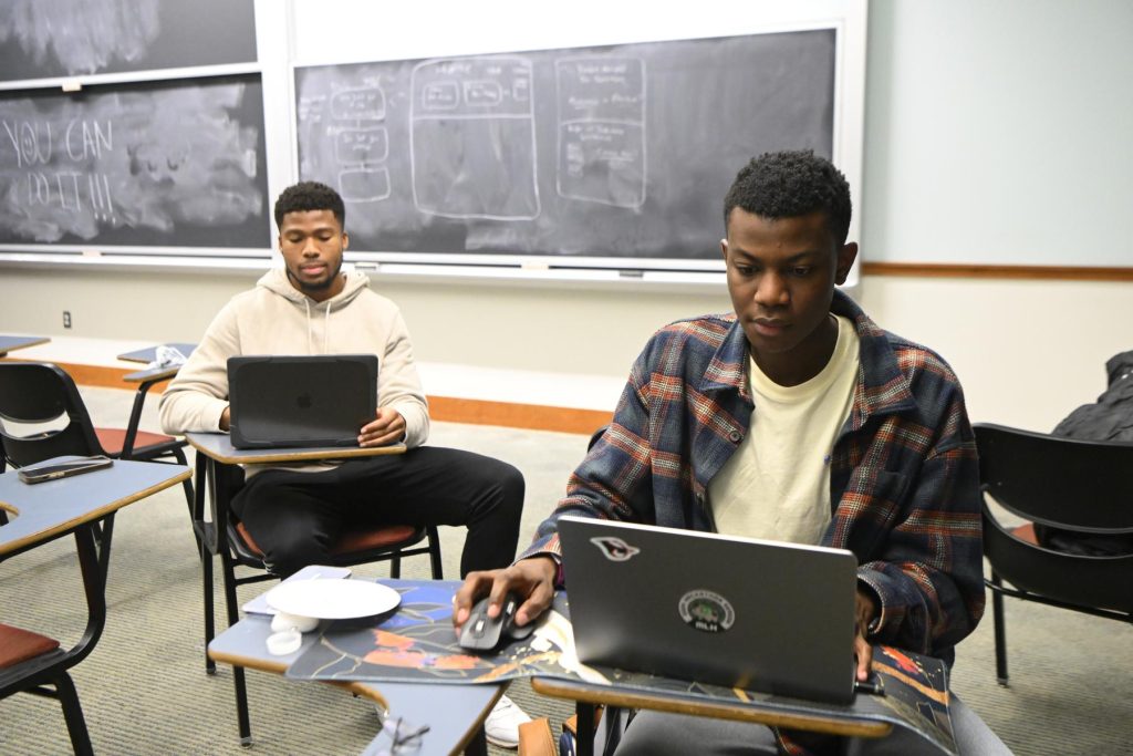 Students work on laptops.