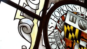 The stained glass window in Gilman Hall depicting the Johns Hopkins seal.