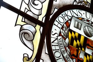 The stained glass window in Gilman Hall depicting the Johns Hopkins seal.