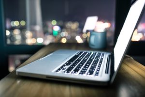 Laptop on table at night.