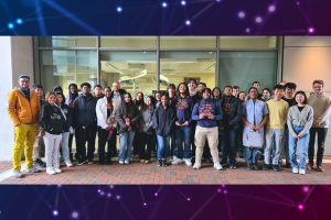 Students from the Baltimore Polytechnic Institute pose in the Hackerman breezeway, bookended by Mathias Unberath and Benjamin Killeen.