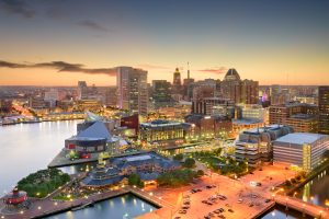 Baltimore inner harbor and downtown skyline at dusk.