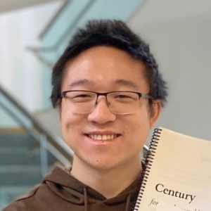 Headshot of Alex Ma holding a spiral-bound book with "Century" on the cover.