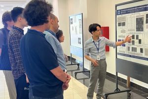Samuel Remedios present his poster to onlookers.