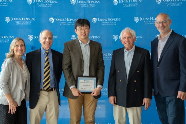 Joanne Selinski, Joshua J. Reiter, Ziang Xiao, Joel Dean, Jr., and Randal Burns pose together. Xiao holds his award.