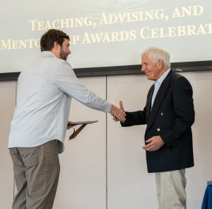 Eric Nalisnick shakes hands with Joel Dean, Jr.