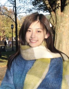 Jiaqi Yu in a scarf and sweater on the Homewood campus.