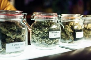 A dispensary worker vending jars of cannabis.