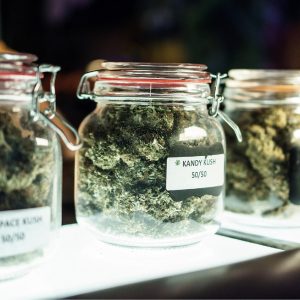 A dispensary worker vending jars of cannabis.