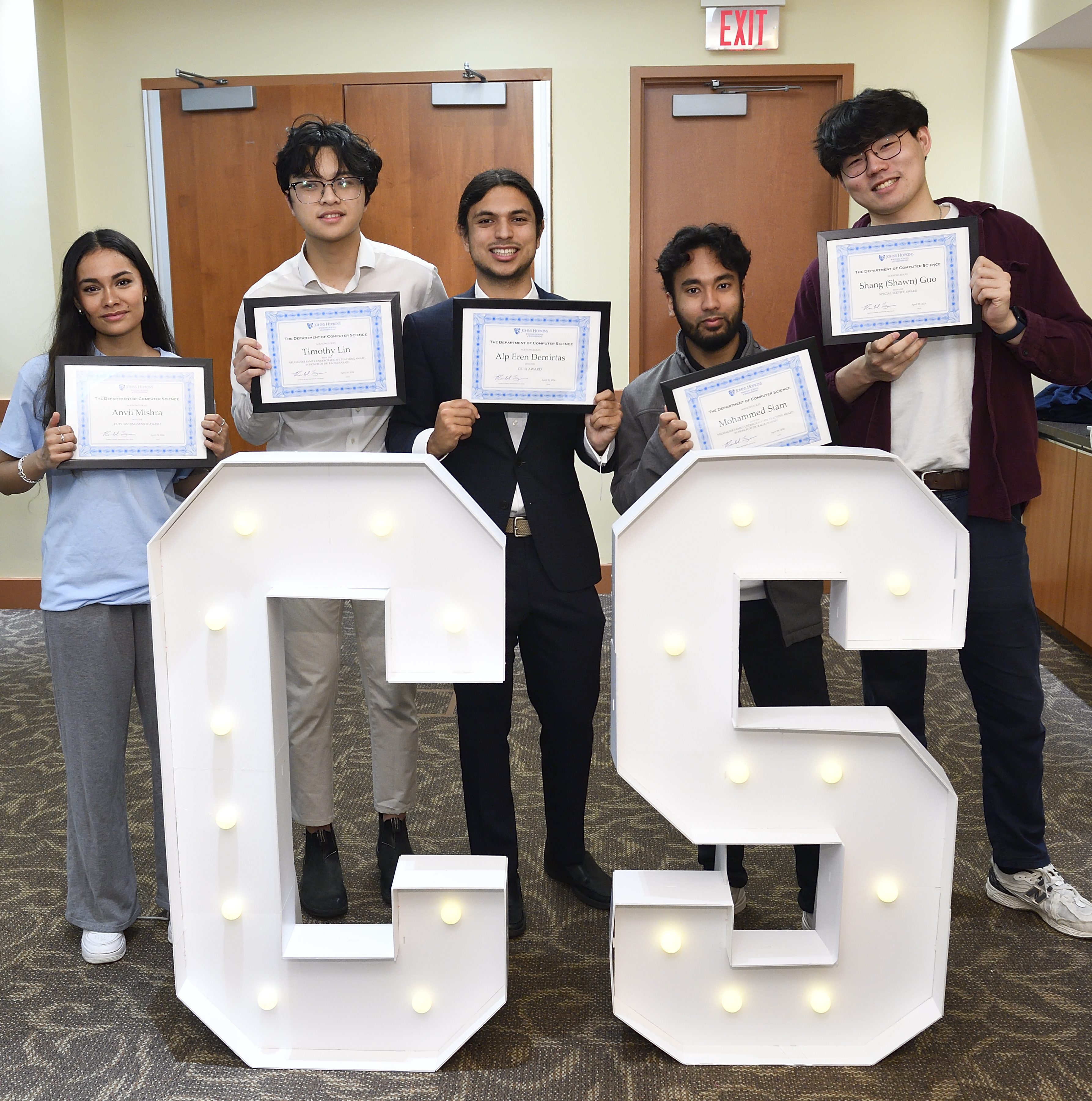 Anvii Mishra, Timothy Lin, Alp Eren Demirtas, Mohammed Siam, and Shang “Shawn” Gao pose with their awards behind large CS letters.