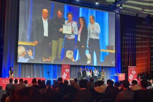 The team accepts its award onstage at ICRA 2026.