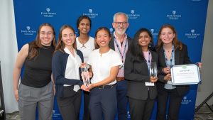 The TriageNow and RescueReady teams holding their awards and posing with Larry Aronhime at HopStart 2025.