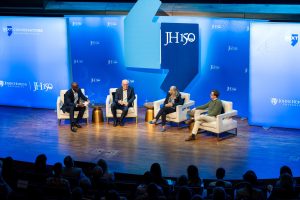 Panelists on the stage at Hopkins Bloomberg Center.