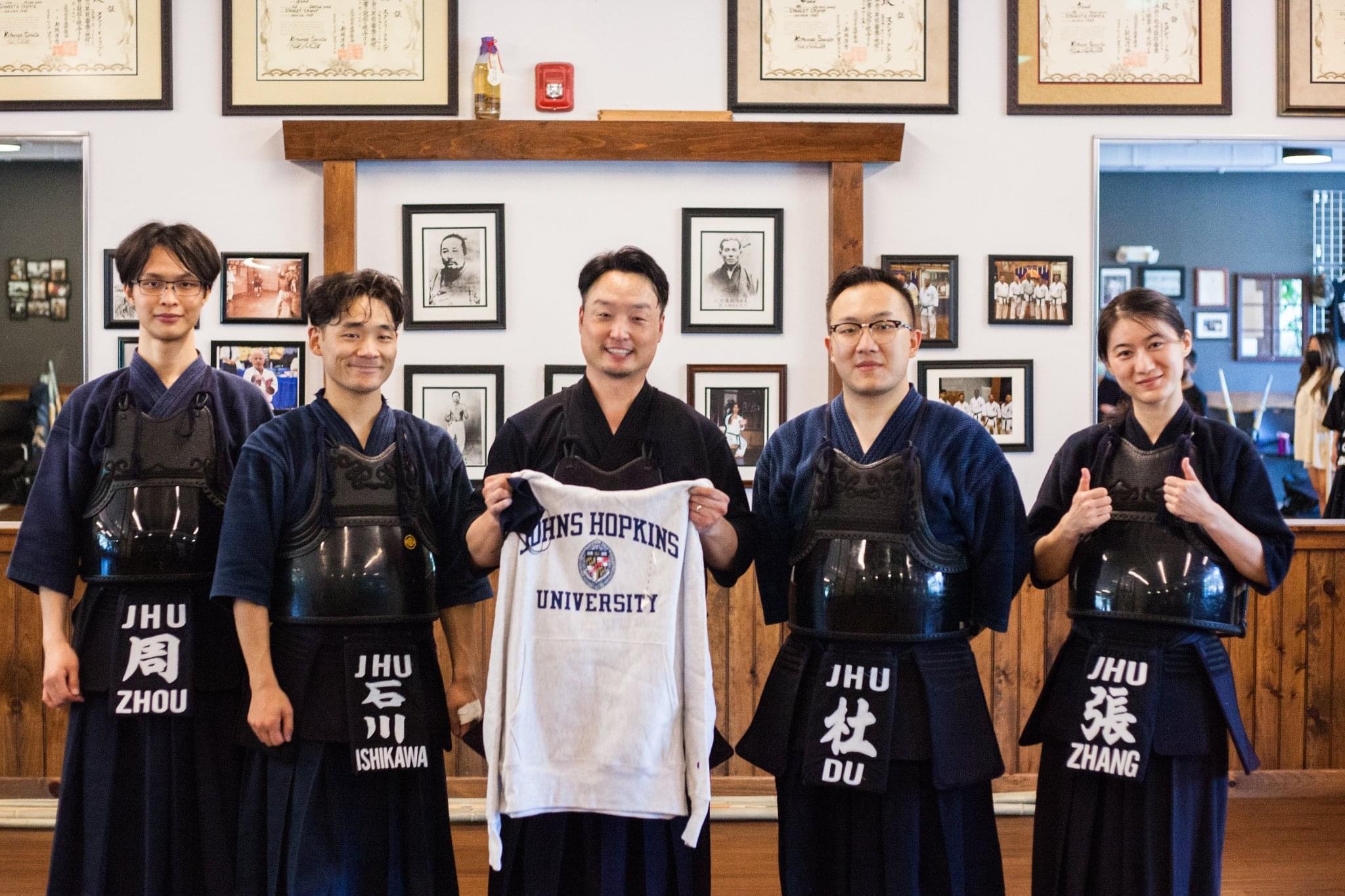 A photo with Chi sensei and JHU kendo club members.